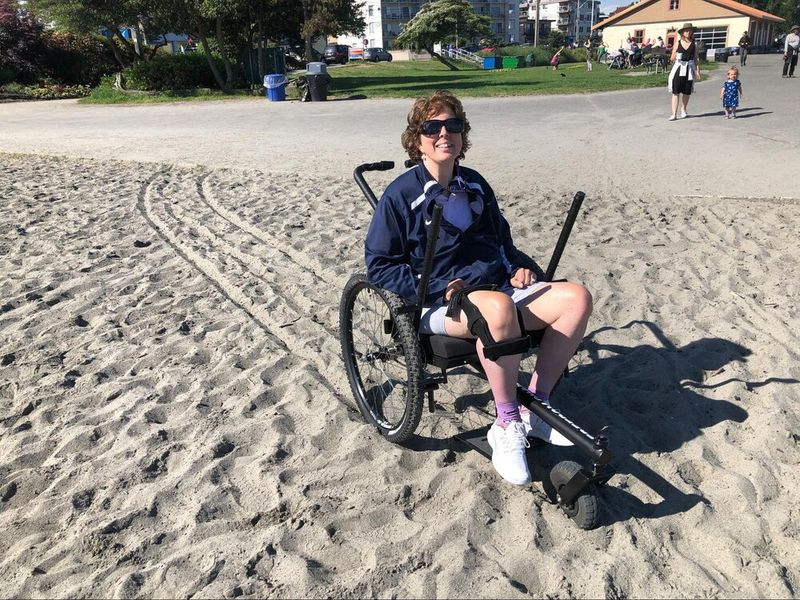 The Best Accessible Beaches on the East and West Coasts, own equipment: person in GRIT Freedom Chair made trail off pavement on sandy beach