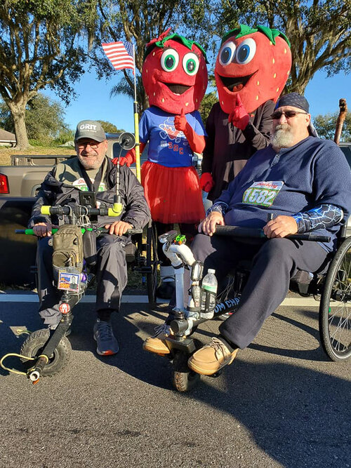 How Easy Is GRIT Freedom Chair To Push or Use for Seniors: Jerry and Gator road race in GRIT Freedom Chairs and pose with strawberry mascots