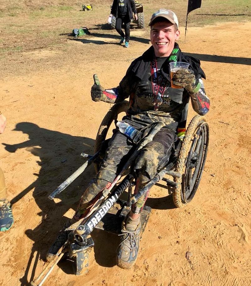Flying With the GRIT Freedom Chair rider perspective: Tyler Rich using all-terrain wheelchair on dirt after outdoor obstacle course event