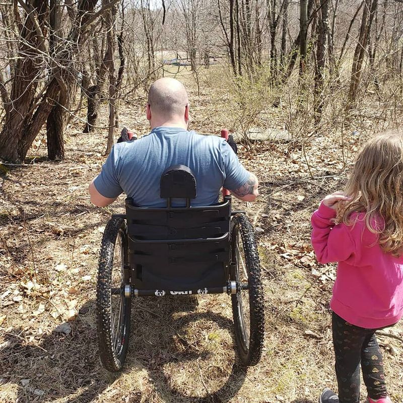 How To Ask for Personal Mobility Equipment Funding Help Step #4, Complete the Conversation: child walks next to adult in GRIT Freedom Chair