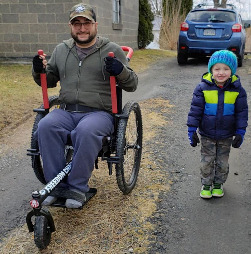 Why Would I Need an Outdoor Wheelchair? Join friends and family outdoors: Nate in GRIT Freedom Chair next to young son on uneven driveway
