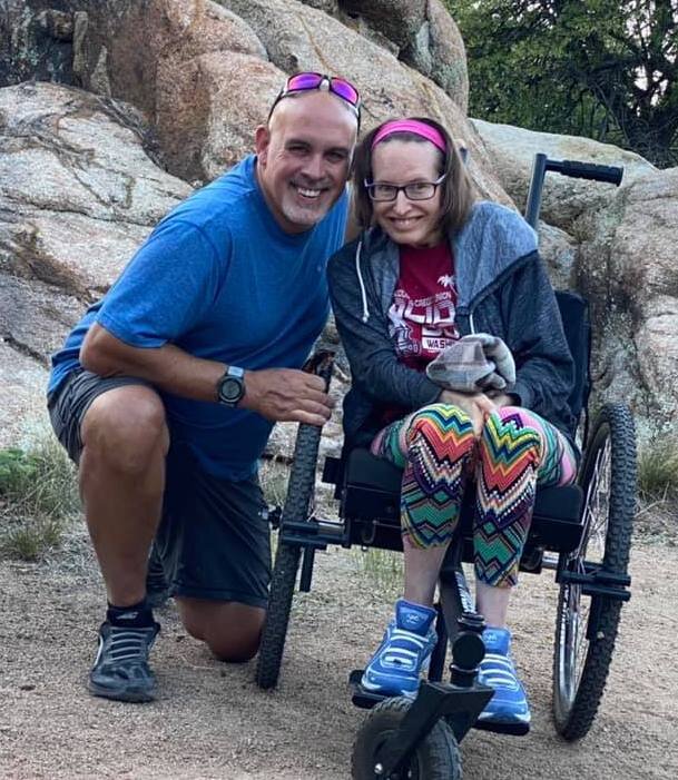 The GRIT Freedom Chair Push Configuration: Colleen and Patrick enjoying a trail with push accessories on GRIT offroad wheelchair