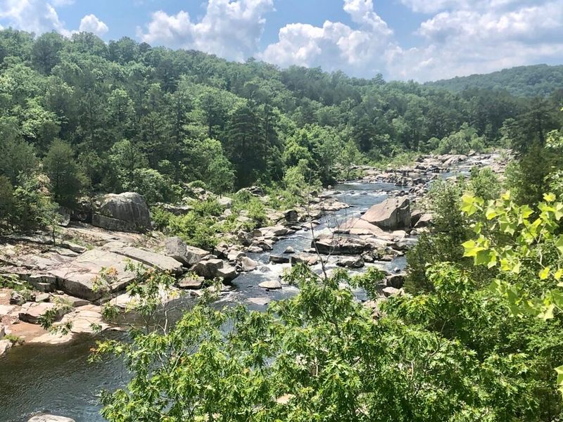 Accessible Hiking Trails You’ve Never Heard Of, Tiemann Shut-ins Trail in MO: river lined by rocks and greenery in Fredericktown, Missouri